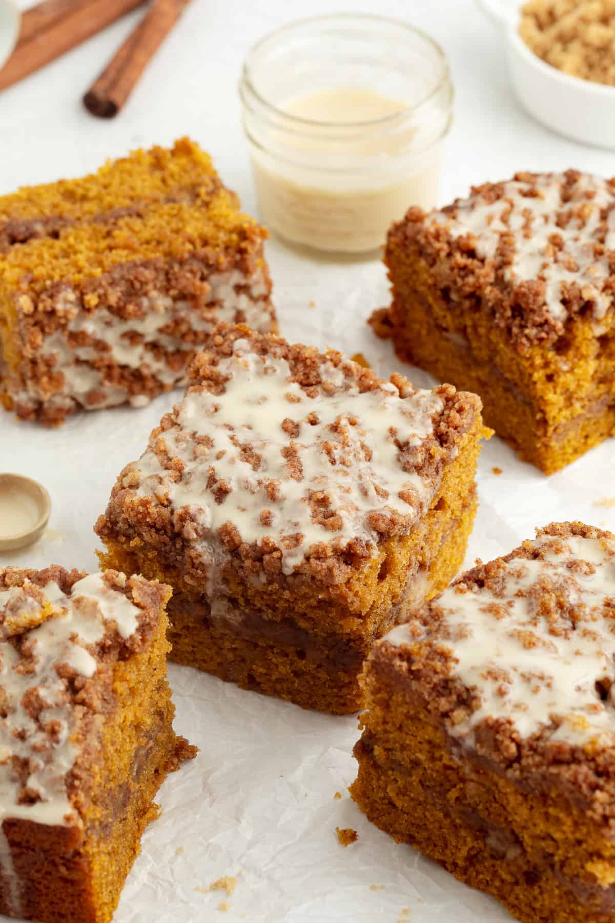 Slices of pumpkin coffee cake topped with maple glaze.