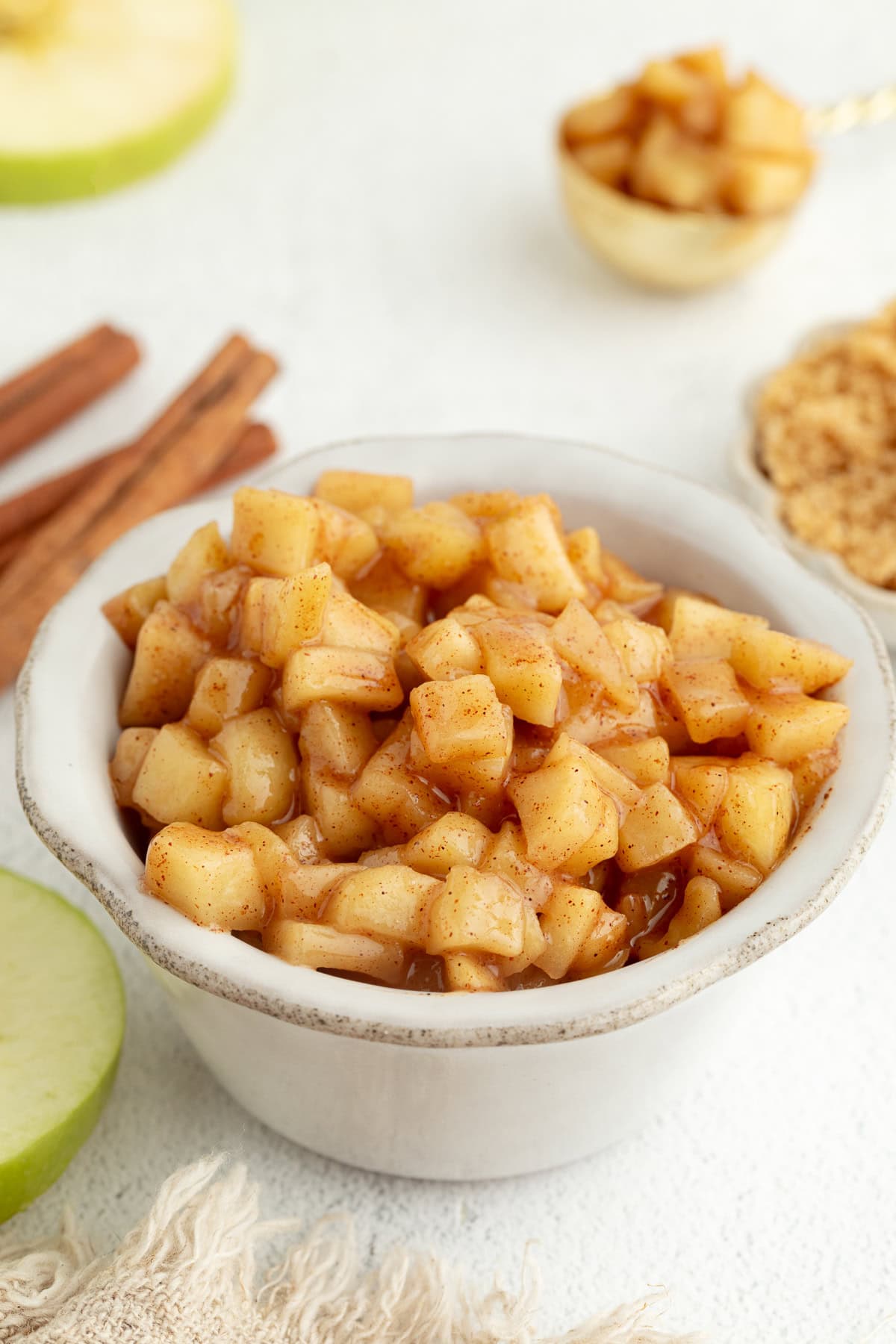 Stovetop apple pie filling in a white bowl.