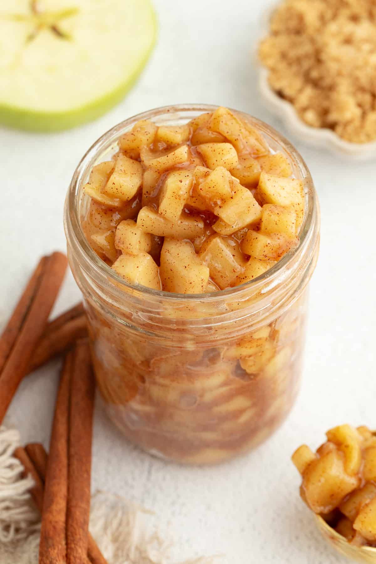 Make the best homemade apple pie filling on the stovetop with fresh apples, brown sugar, and cinnamon. Perfect for pies, crisps, and more! Stovetop apple pie filling in a glass mason jar.