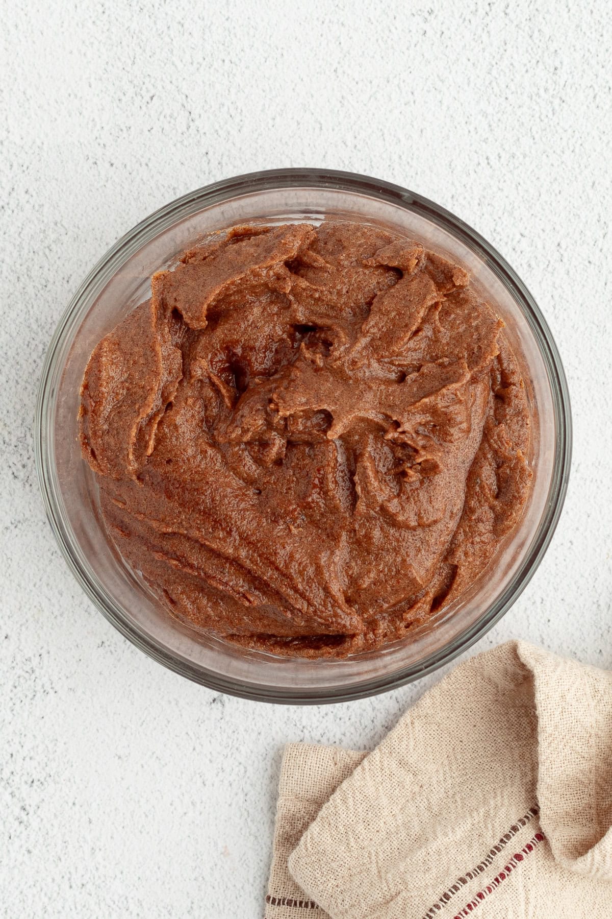 Homemade apple cinnamon rolls are golden-baked with warm cinnamon apple filling and topped with creamy brown butter cream cheese frosting. Cinnamon brown sugar filling in a mixing bowl.