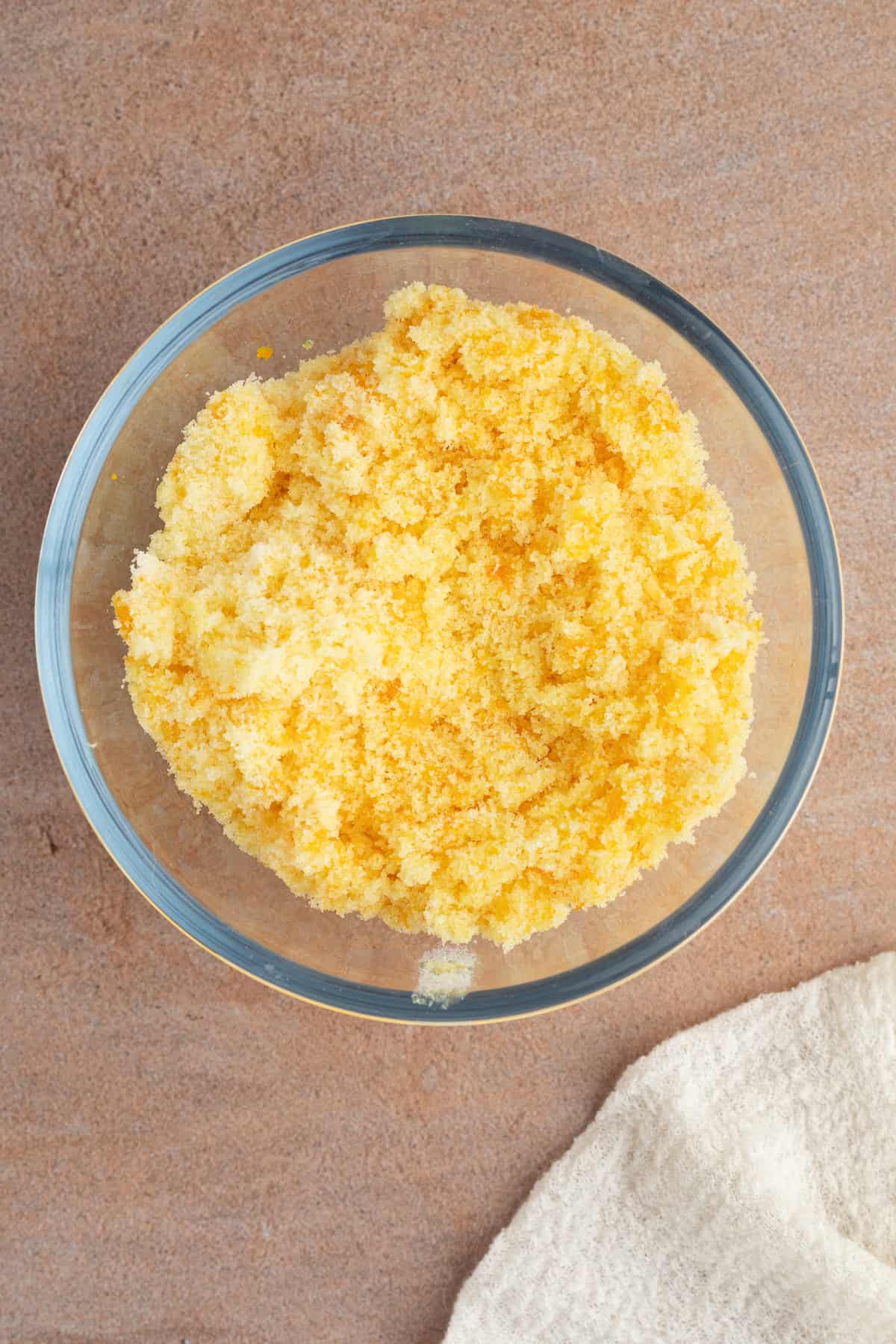 These moist cranberry orange muffins are full of real orange juice, fresh zest, and sweet-tart cranberries. So easy to make and big on flavor! Orange zest combined with sugar, oil, and butter in a mixing bowl.