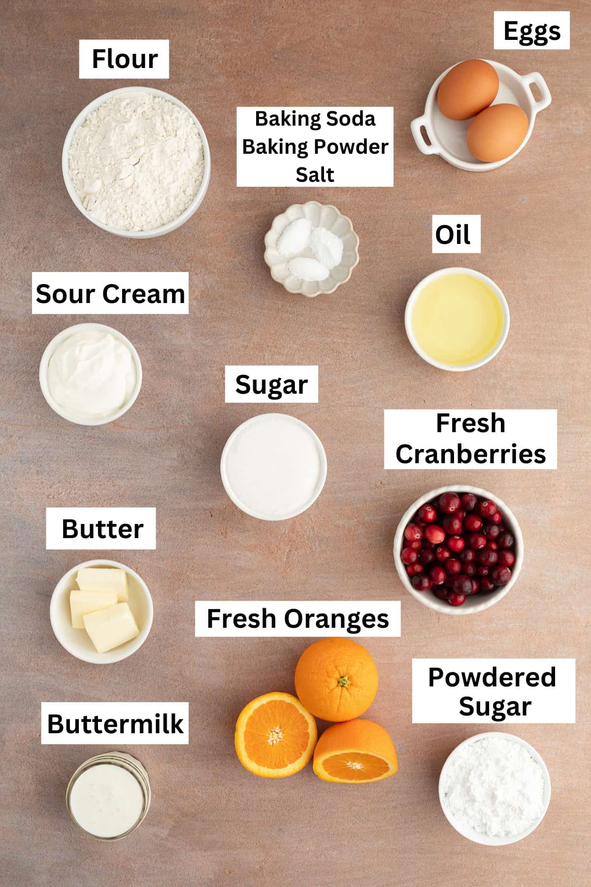 These moist cranberry orange muffins are full of real orange juice, fresh zest, and sweet-tart cranberries. So easy to make and big on flavor! Cranberry orange muffins ingredients with text labels overlaying each ingredient.