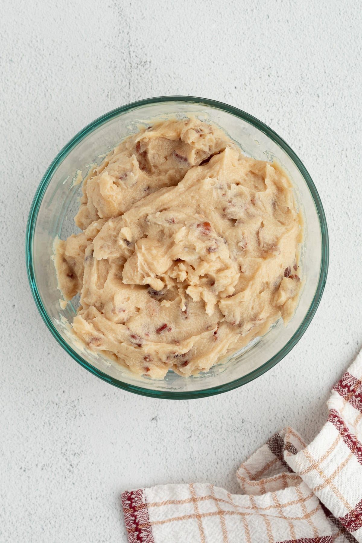These homemade sticky buns are filled with warm cinnamon and nutty pecans, with a gooey caramel topping. The dough needs just 1 hour to rise! Caramel pecan topping in a mixing bowl.
