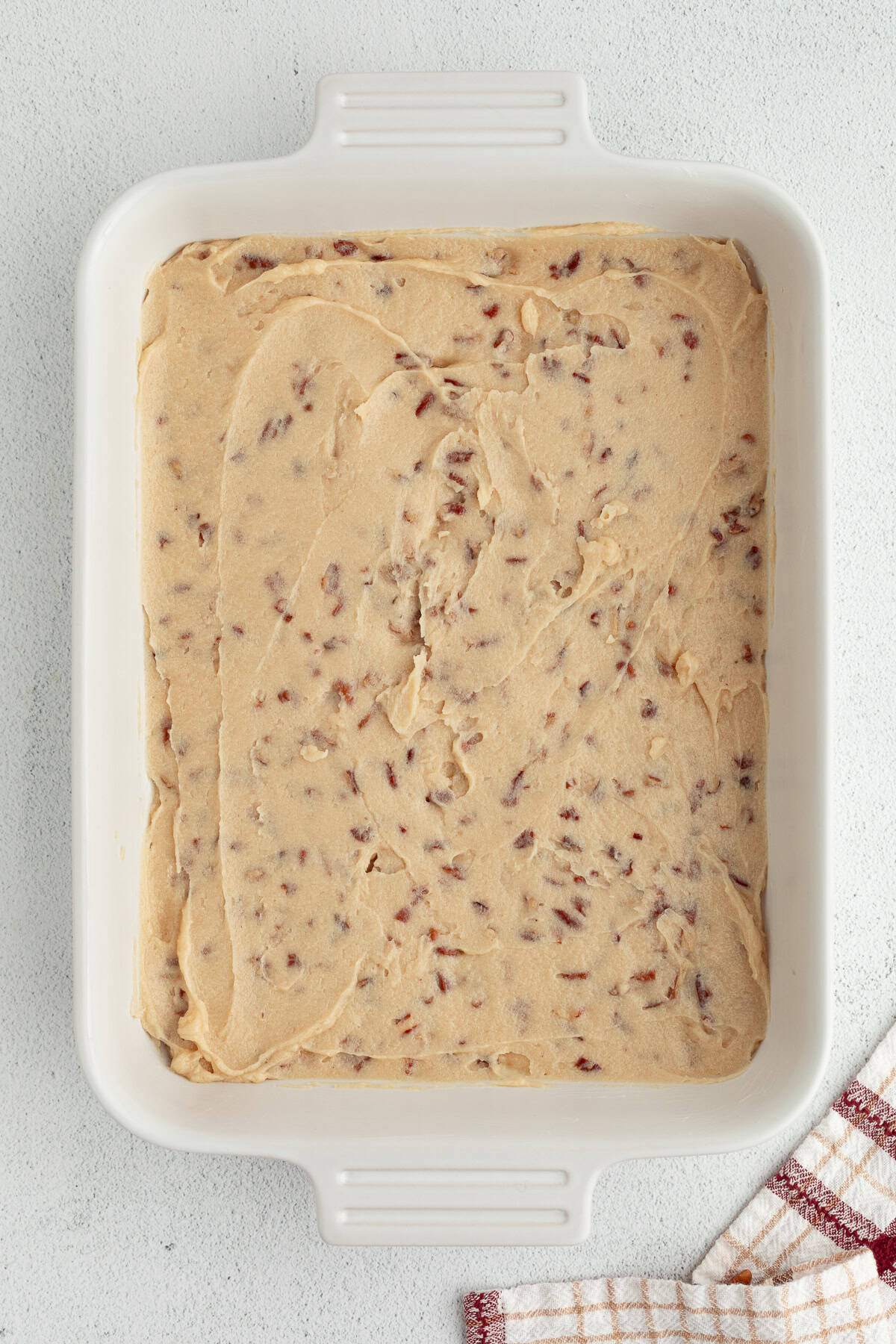 These homemade sticky buns are filled with warm cinnamon and nutty pecans, with a gooey caramel topping. The dough needs just 1 hour to rise! Caramel pecan mixture in the bottom of a casserole dish,