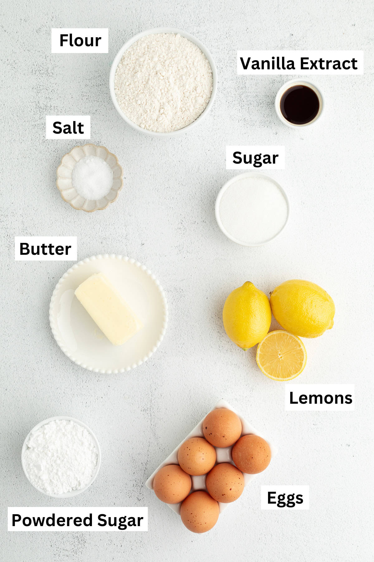 Make the best lemon bars that are perfectly baked with a soft, buttery shortbread crust and a sweet, tangy, creamy lemon curd filling. Lemon bars ingredients with text labels overlaying each ingredient.