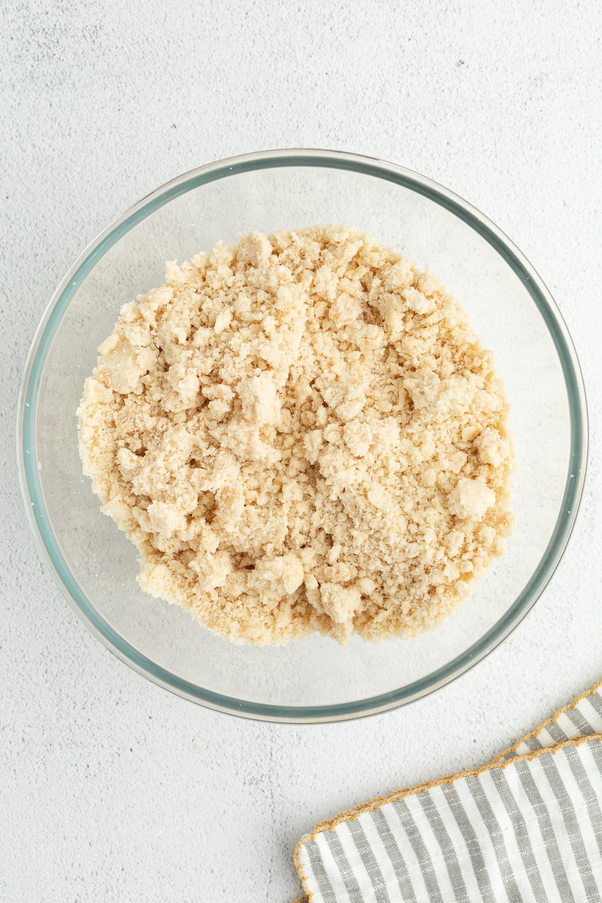 Make the best lemon bars that are perfectly baked with a soft, buttery shortbread crust and a sweet, tangy, creamy lemon curd filling. Crumbly shortbread crust mixture in a glass bowl.