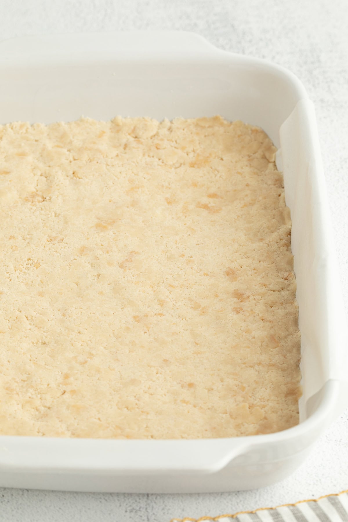 Make the best lemon bars that are perfectly baked with a soft, buttery shortbread crust and a sweet, tangy, creamy lemon curd filling. Shortbread crust pressed inside a 9x13 baking dish.