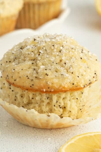 A lemon poppy seed muffin garnished with coarse sugar.