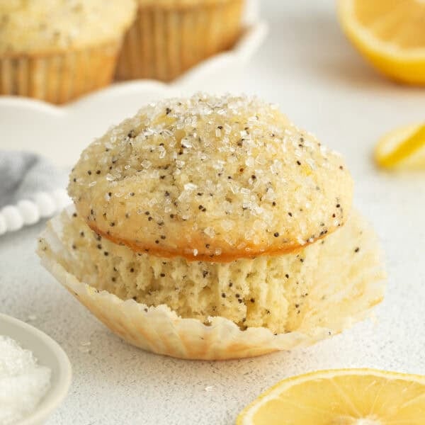 A lemon poppy seed muffin garnished with coarse sugar.