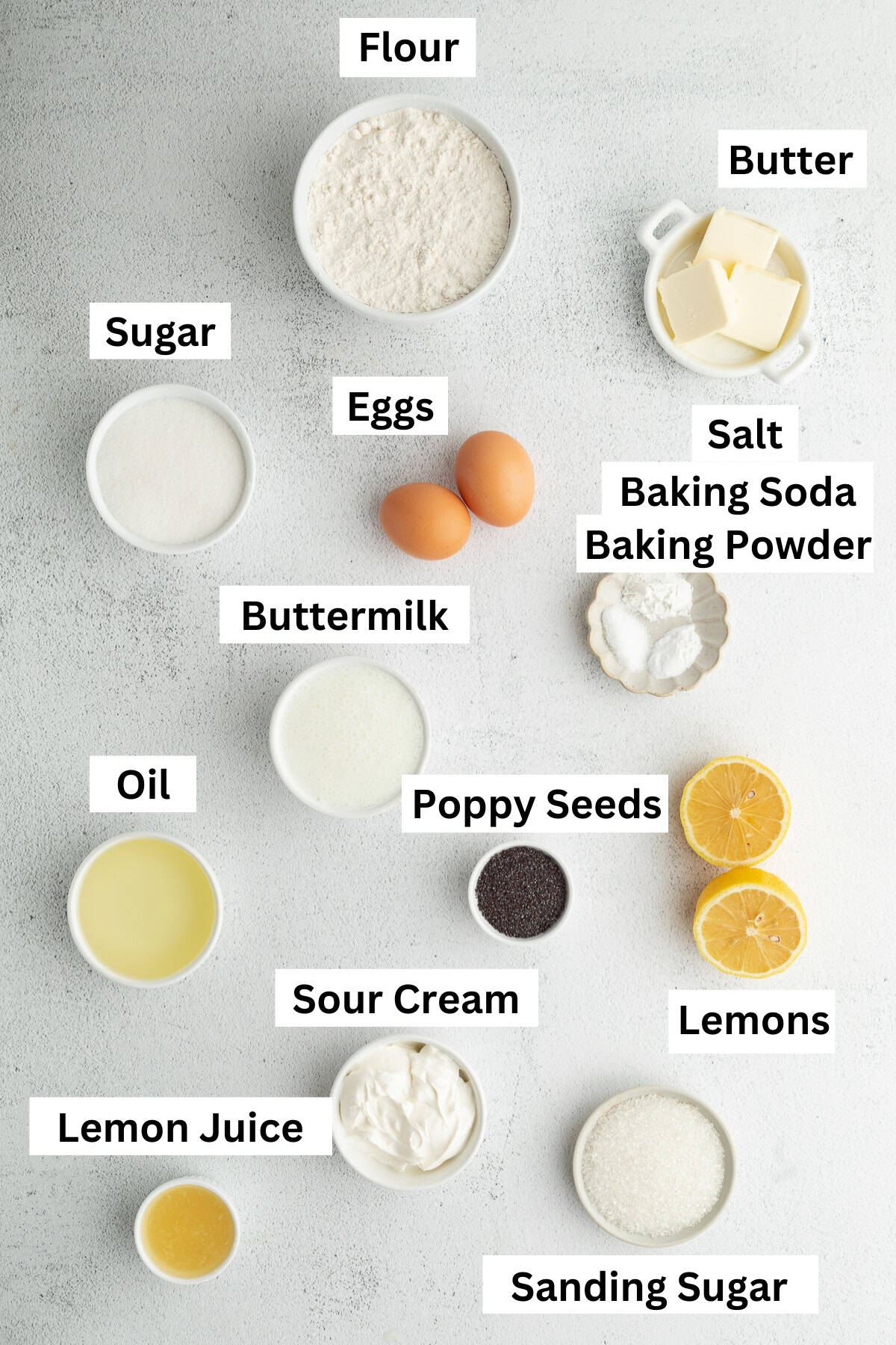 Moist, tangy, and topped with sanding sugar, these bakery-style lemon poppyseed muffins are the perfect breakfast treat. And so easy to make! Lemon poppy seed muffin ingredients with text labels overlaying each ingredient.