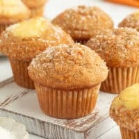 Assorted carrot cake muffins, some filled with cream cheese.