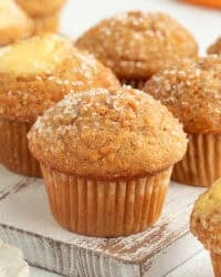 Assorted carrot cake muffins, some filled with cream cheese.