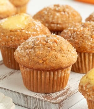 Assorted carrot cake muffins, some filled with cream cheese.