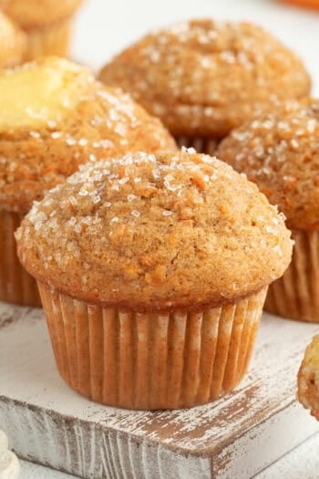 Assorted carrot cake muffins, some filled with cream cheese.