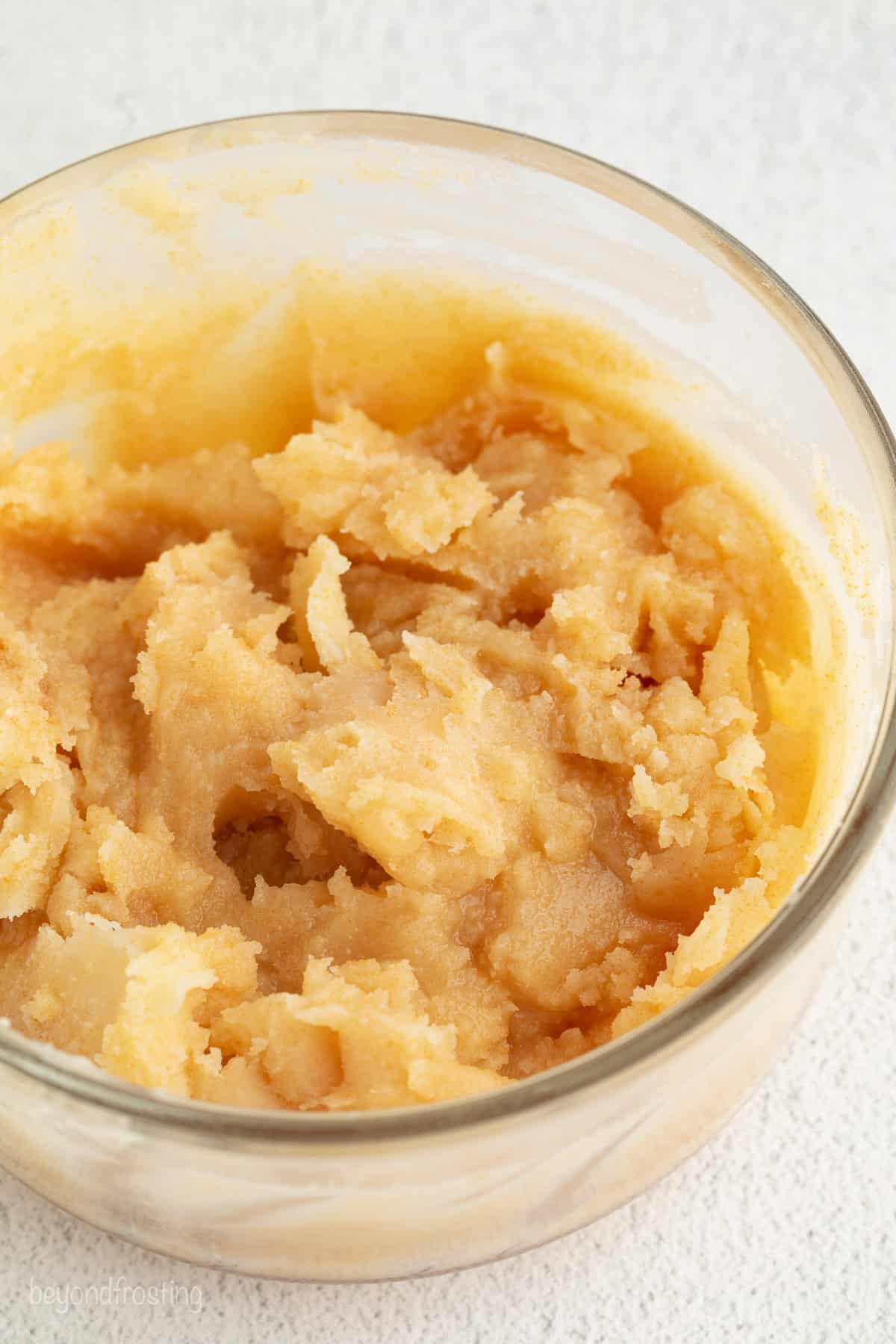 A clear glass bowl with chilled brown butter