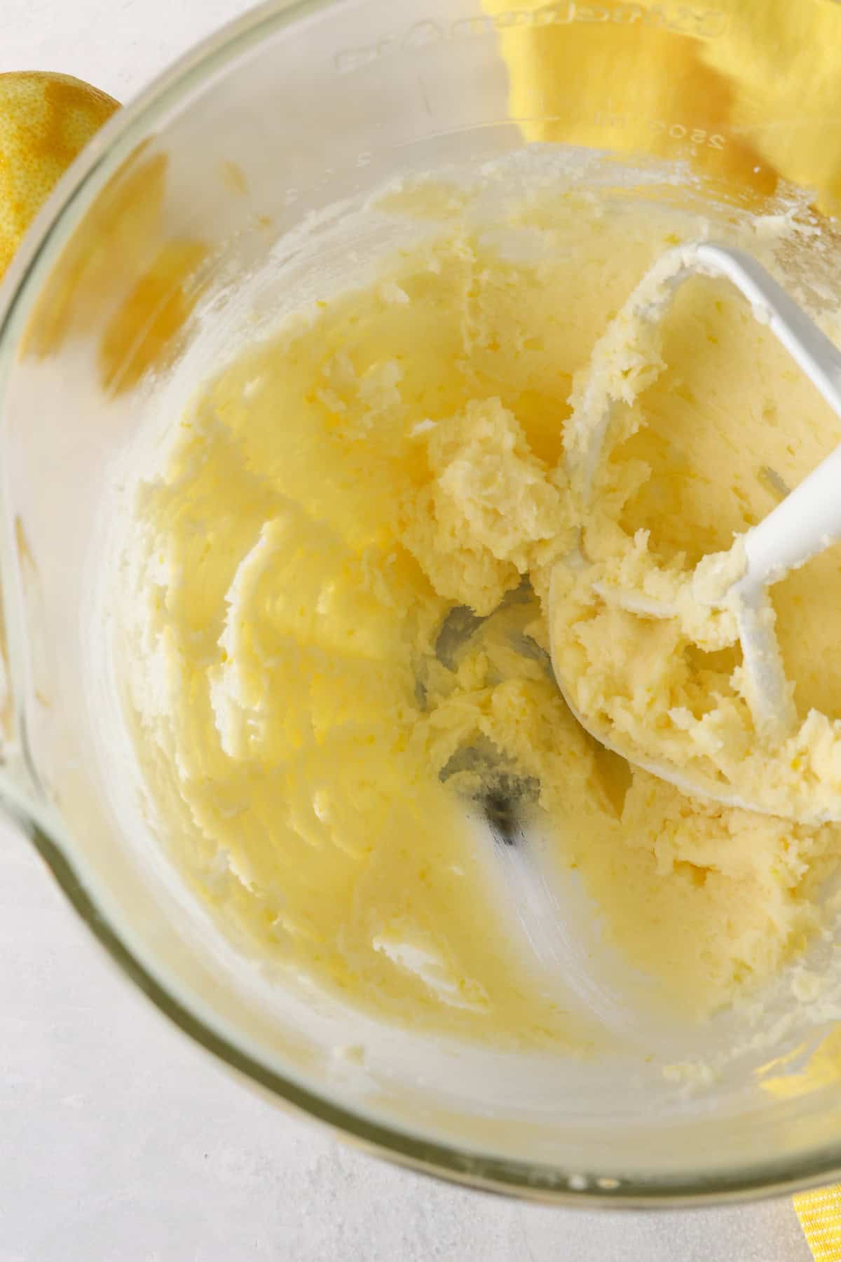 These slice-and-bake lemon shortbread cookies are crisp, buttery, and melt-in-your-mouth, rolled in sanding sugar for sweet, crunchy edges. Wet shortbread dough ingredients creamed together in a mixing bowl.