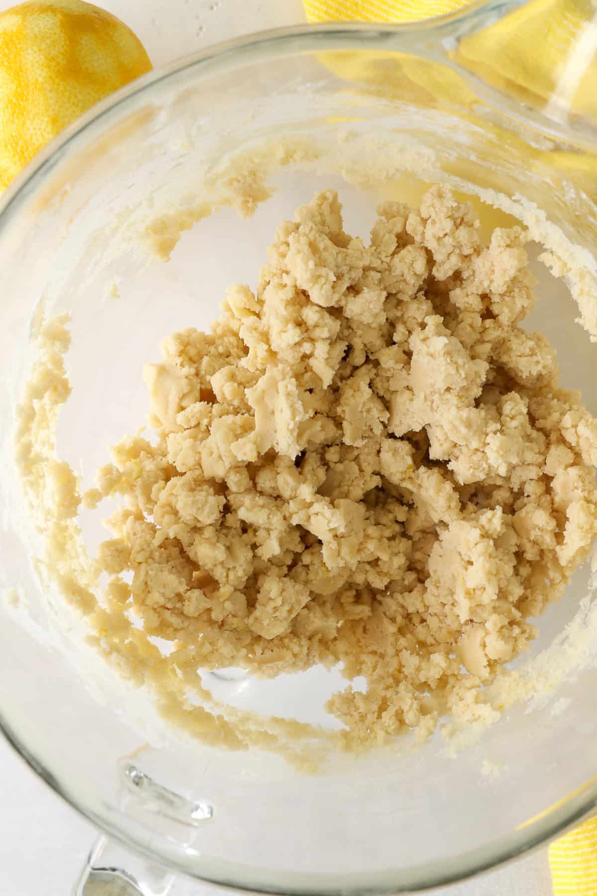 These slice-and-bake lemon shortbread cookies are crisp, buttery, and melt-in-your-mouth, rolled in sanding sugar for sweet, crunchy edges. Lemon shortbread cookie dough in a mixing bowl.