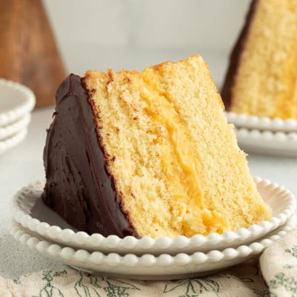 A slice of Boston cream pie with custard filling on a plate.