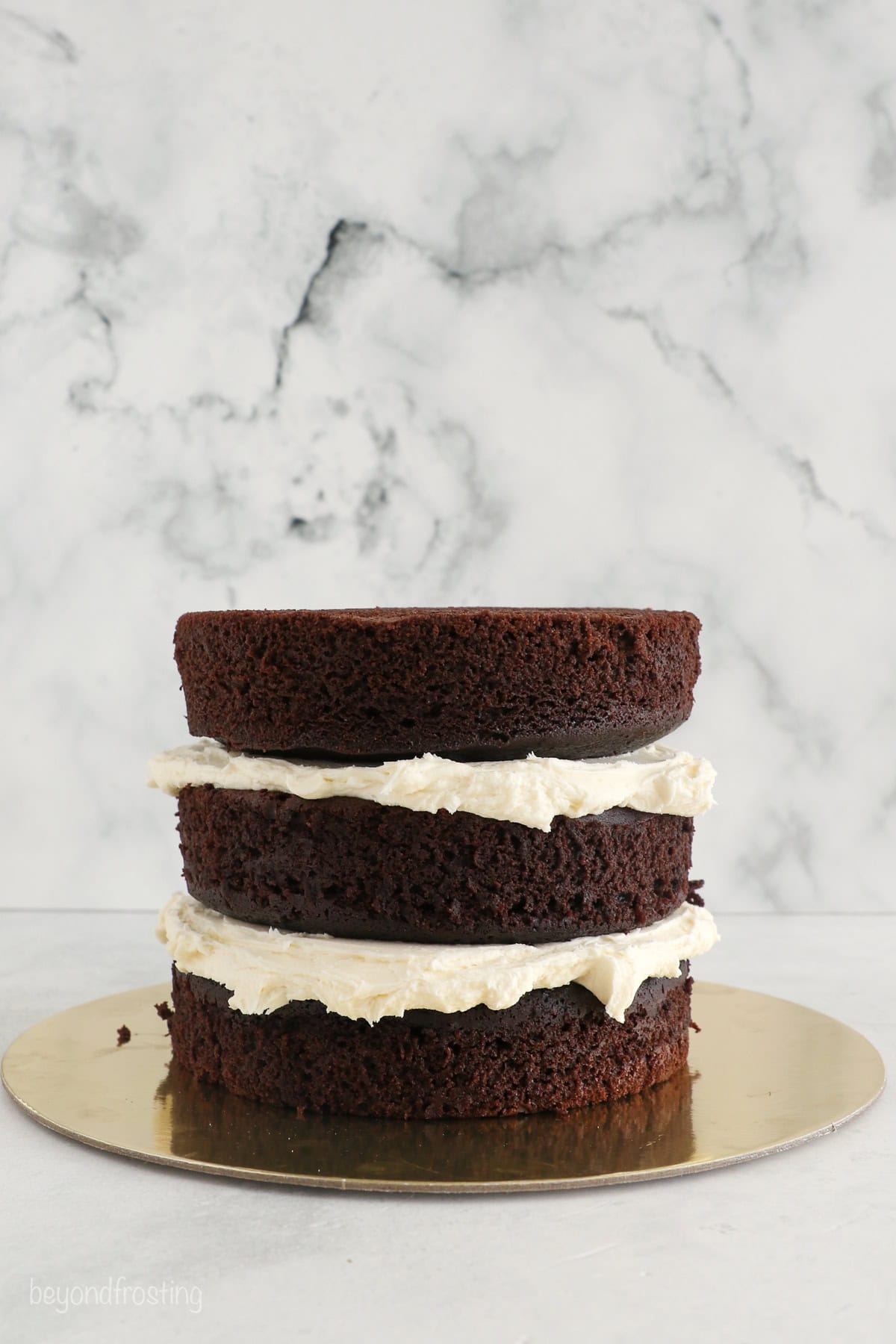 With racing-red frosting and just a little fondant, this Lightning McQueen layer cake is perfect for a kids’ Cars birthday party! Three chocolate cake layers stacked and filled with frosting.