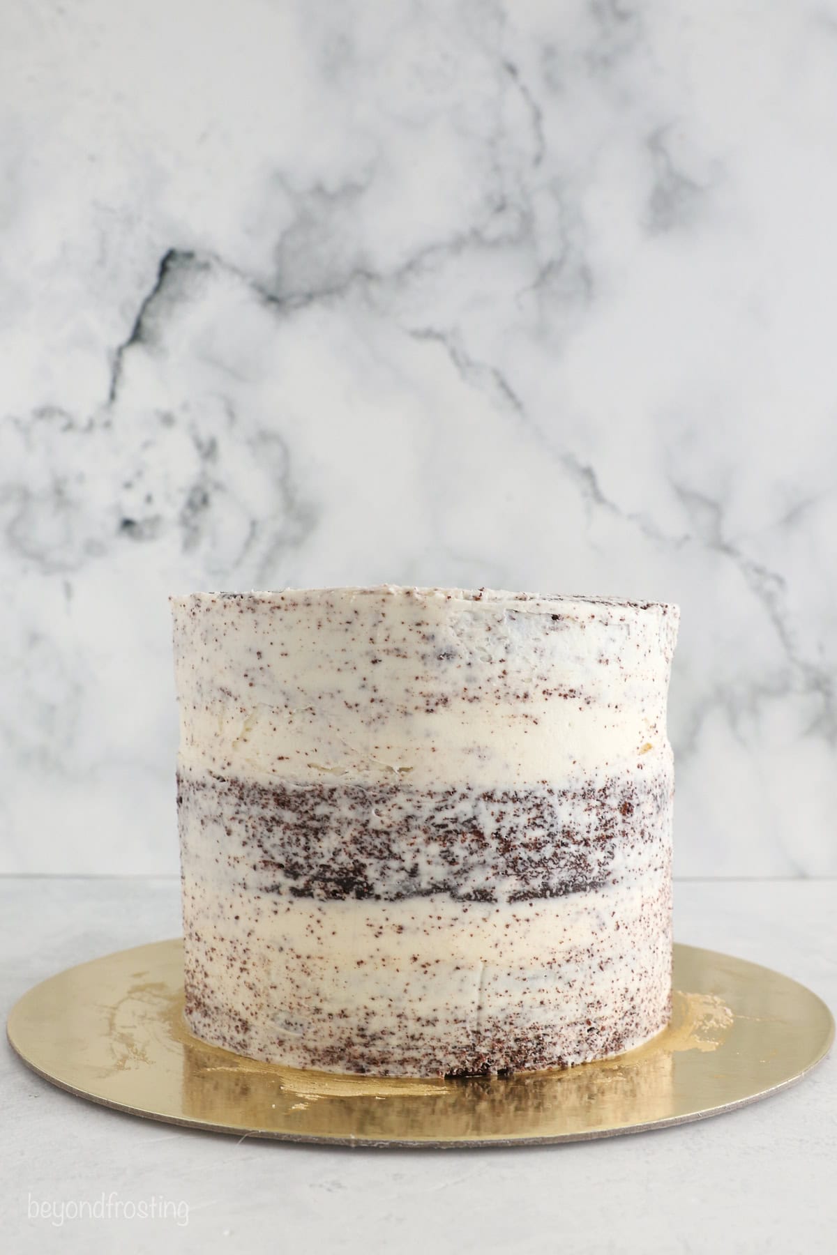 With racing-red frosting and just a little fondant, this Lightning McQueen layer cake is perfect for a kids’ Cars birthday party! A three-layer chocolate cake covered with a crumb coat.