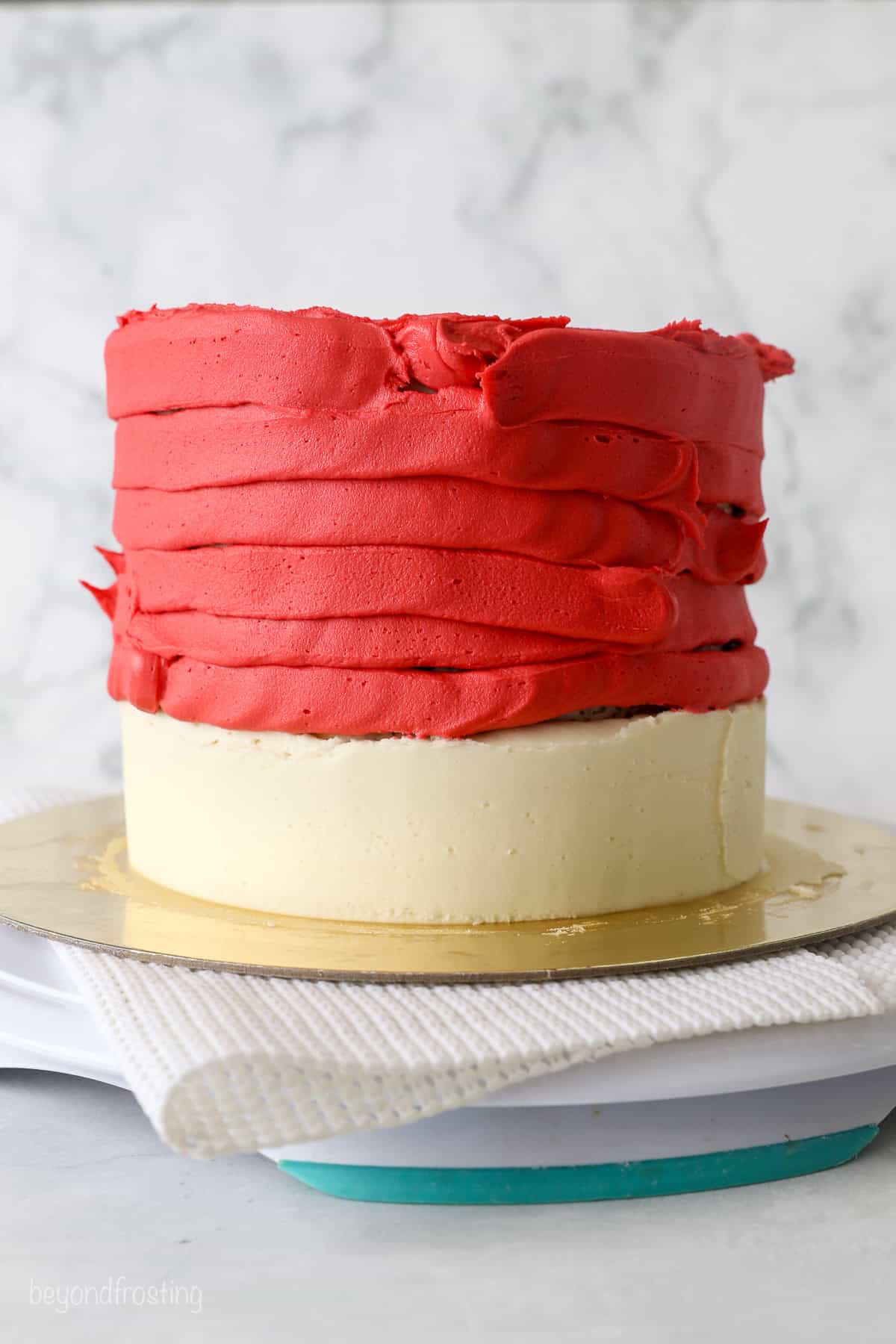 With racing-red frosting and just a little fondant, this Lightning McQueen layer cake is perfect for a kids’ Cars birthday party! Red buttercream frosting piped around the top of a three-layer cake.