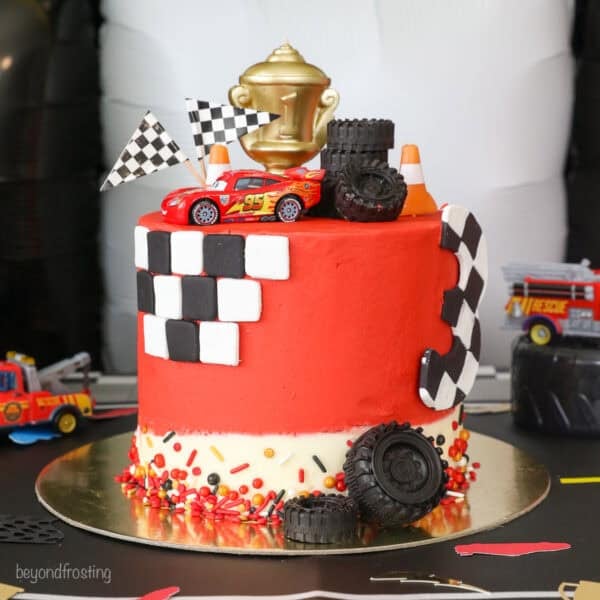 A Lightning McQueen cake with racing themed decorations.