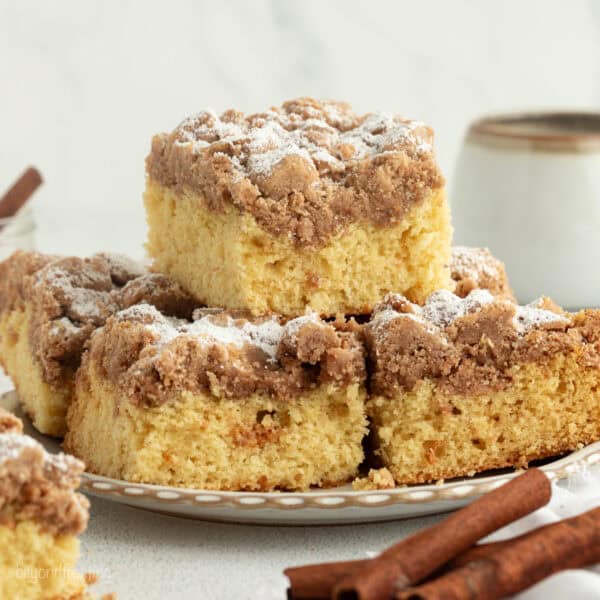 New York crumb cake sliced and stacked on plate.