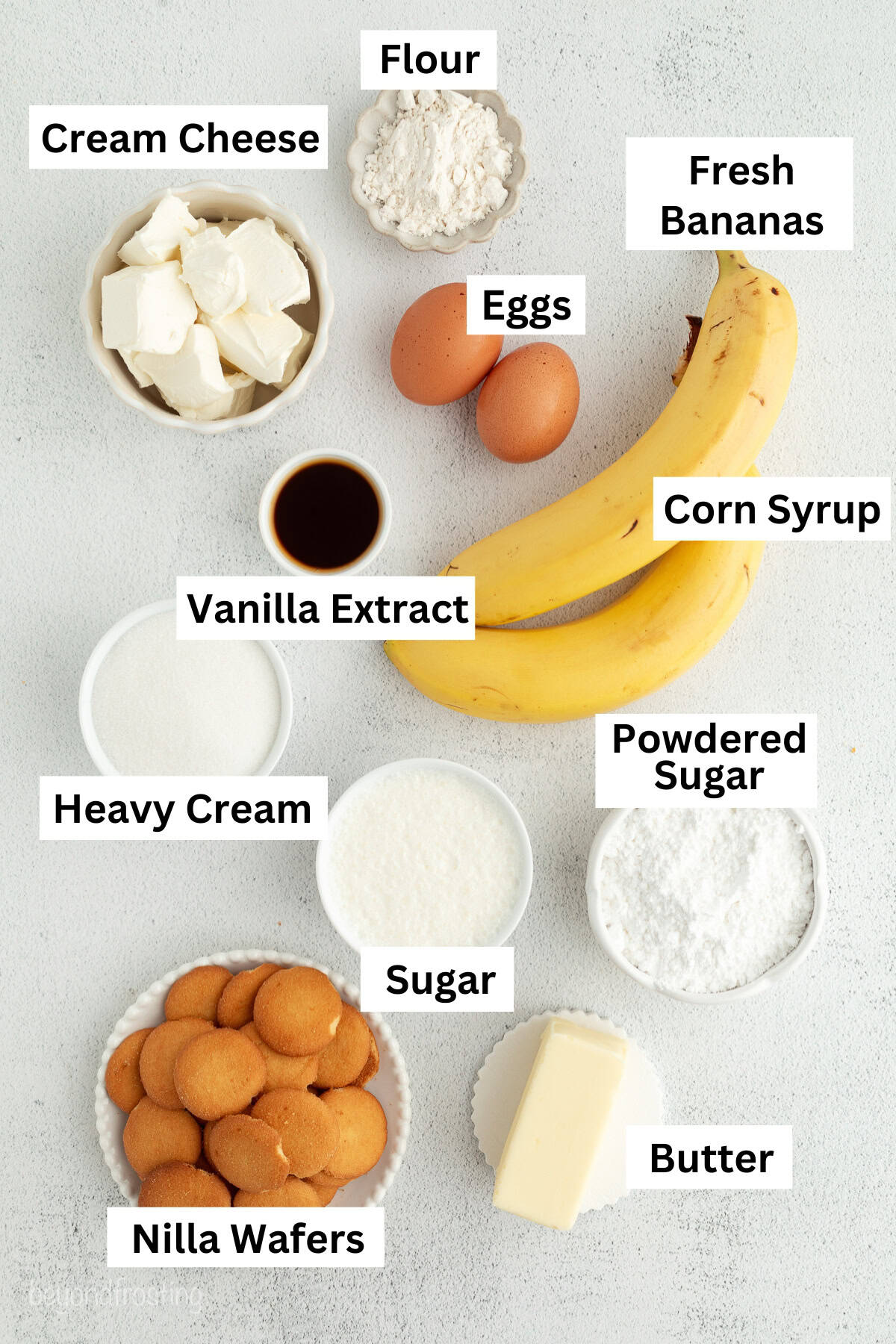 Make the best no-bake banana pudding cheesecake with creamy cheesecake filling, fresh banana slices, homemade pudding, and whipped cream. No-bake banana pudding cheesecake ingredients with text labels.