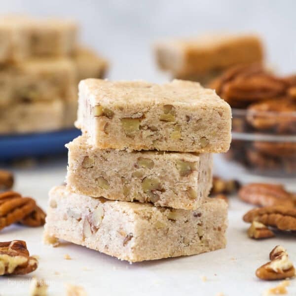 Three pecan shortbread cookies stacked on a countertop.