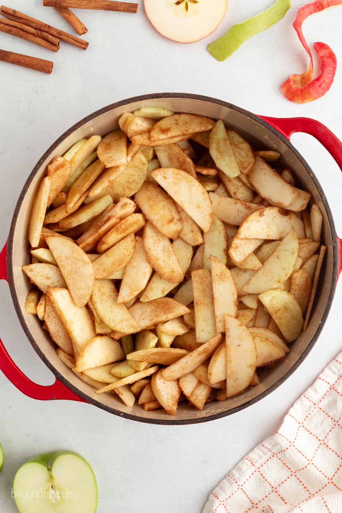 You don't need to stir this cozy apple dump cake! Dump juicy cinnamon apples into a cake pan, top with dry cake mix and butter, and bake. Cinnamon apples in a bowl.