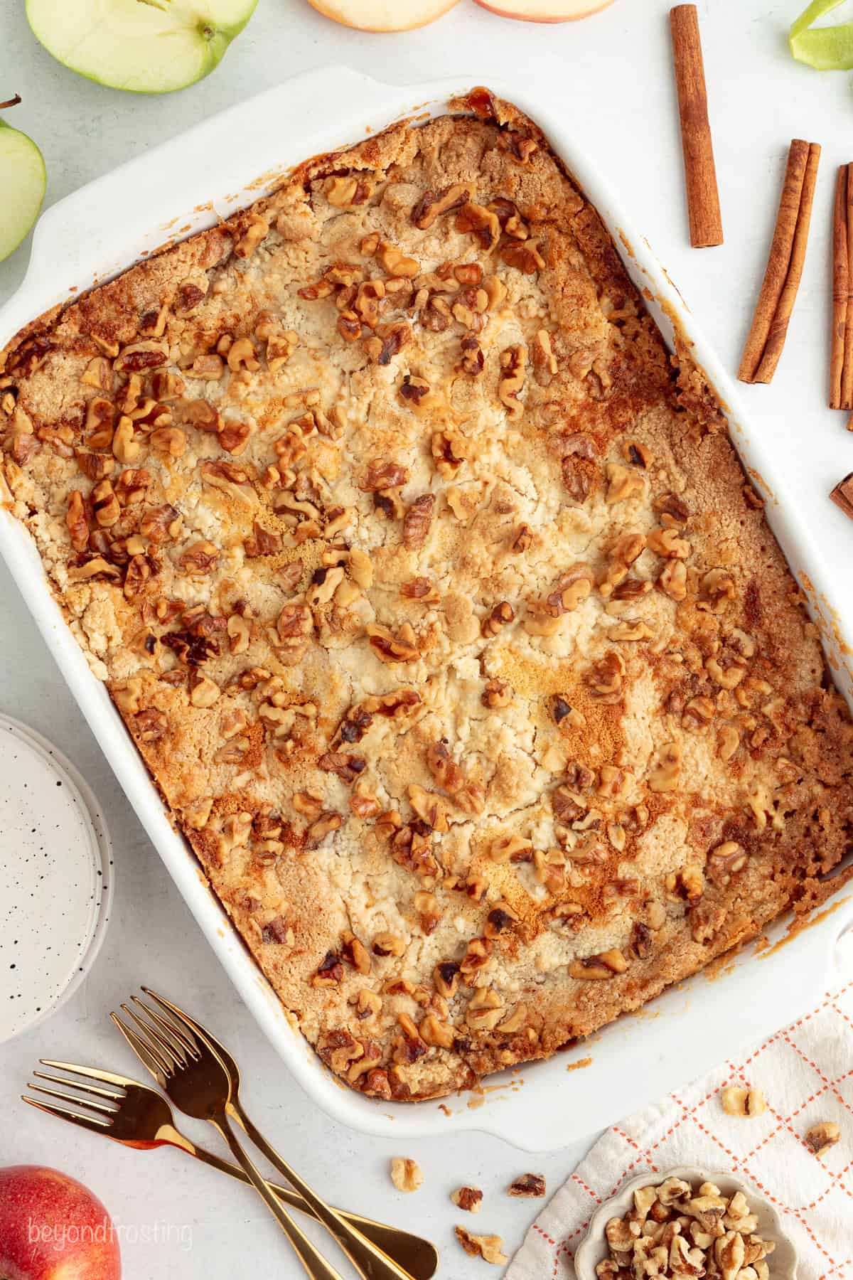 You don't need to stir this cozy apple dump cake! Dump juicy cinnamon apples into a cake pan, top with dry cake mix and butter, and bake. Freshly baked apple dump cake with a cake mix and butter topping.