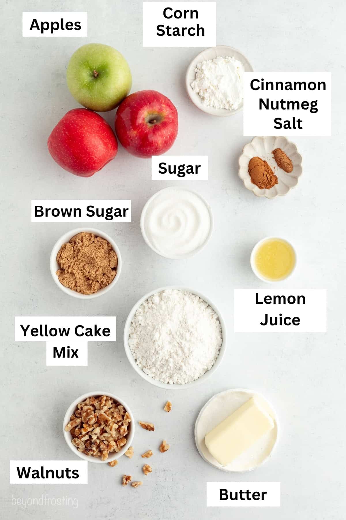 You don't need to stir this cozy apple dump cake! Dump juicy cinnamon apples into a cake pan, top with dry cake mix and butter, and bake. Apple dump cake ingredients with text labels.