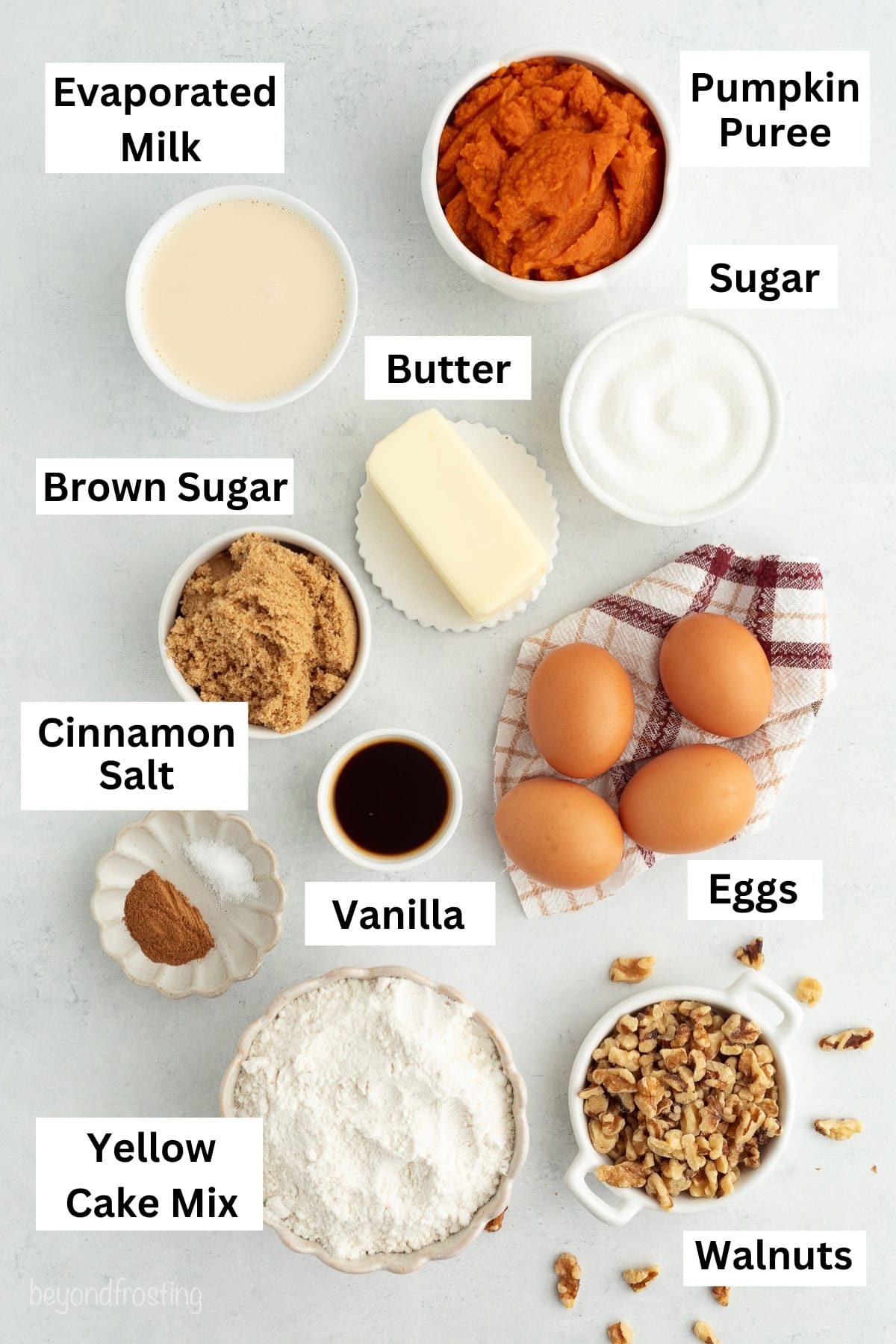 Fall pumpkin crunch cake is an easy, dump cake-style dessert with rich pumpkin filling and a buttery, crunchy cake mix layer with walnuts. Pumpkin dump cake ingredients with text labels.